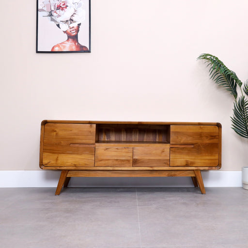 Contemporary fusion of style and functionality, made with solid teak wood designed to elevate your home entertainment experience. This TV unit seamlessly combines modern aesthetics with practical storage solutions, creating a centerpiece that enhances both form and function.
Overall dimensions: Lenghth: 150cm, Depth-45cm, Height-60cm.