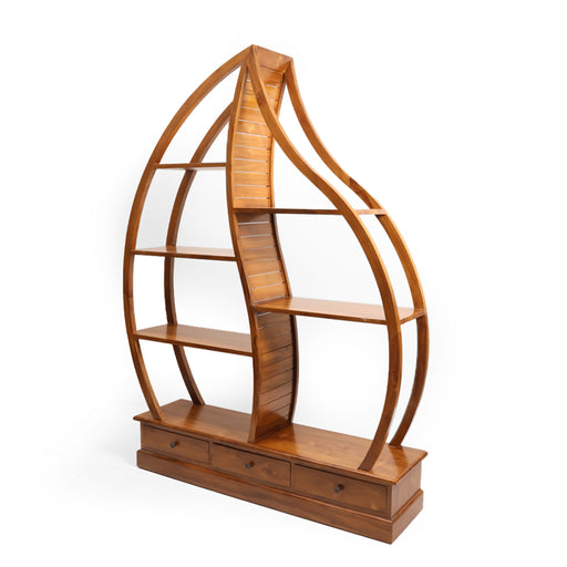 The Aria Sculptural Shelf is where high-end art meets functional design. Inspired by the fluid lines of nature, this statement piece features a breathtaking dual-curved frame that mimics the silhouette of a flame or a delicate leaf. Standing on a substantial plinth base with integrated storage, the Aria is designed for those who want their library or decor collection to be displayed with unparalleled grace.


Bespoke Curved Silhouette: A rare, hand-shaped frame that breaks the conventions of traditional shelving to create a flowing, organic focal point.

Multi-Level Display Gallery: Features staggered open shelving that accommodates various heights, perfect for art, sculptures, and premium book collections.

Plinth Base with Storage: A sturdy, grounded foundation equipped with three smooth-gliding drawers for discreet organization.

Open-View Design: The airy, backless structure allows the colors of your wall to peek through, making the unit feel like a natural extension of your architecture.
