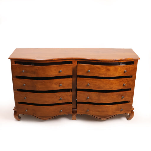 The Genevieve Dresser is a masterwork of traditional cabinetry, defined by its mesmerizing undulating "serpentine" front. Each of the eight drawers is hand-contoured to create a soft, wave-like rhythm that flows across the piece, breaking away from the rigidity of standard furniture. Supported by elegant cabriole feet and a decorative scalloped apron, this dresser is as much a work of art as it is a substantial storage solution for the master suite.


Artisan Serpentine Front: Hand-carved drawer faces create a sophisticated curved silhouette that catches the light and adds visual depth to your room.

Expansive 8-Drawer Storage: A symmetrical layout providing vast organization for linens and wardrobe essentials, finished with vintage-style metal pulls.

Graceful Foundation: Features a hand-scalloped base rail and classic curved feet, giving the piece an airy, elevated feel despite its substantial size.

Polished Masterpiece: Finished to a silky, warm luster that highlights the intricate, flowing grain of the solid wood
