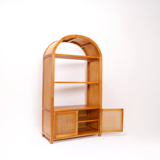 Introduce a powerful element of architectural mastery and warm organic layout to your home with the spectacular Bari Cabinet. Embodying the core Urban Oak design ethos—where forward-thinking, contemporary geometric silhouettes seamlessly intertwine with raw, premium natural luxury—this handcrafted solid teak etagere tower is an absolute masterpiece of functional aesthetics.
By balancing three open-access display tiers with a hidden lower cupboard featuring breathable natural rattan cane doors, it turns everyday organization into a curated, high-end gallery exhibit. In a furniture marketplace saturated with lightweight, mass-produced flat-pack particle board and artificial laminate overlays that sag over time, the Bari demands immediate attention as a genuine wood legacy piece built for the discerning curator.
Why You'll Love It


Premium Solid Teak Craftsmanship: Meticulously handcrafted from 100% genuine solid teak wood, globally celebrated for its outstanding heavy-duty structural density, natural protective oils, and lifelong resilience. This cabinet provides a rock-solid, wobble-free foundation built to last generations.

Statement Archway Design: Defined by its striking, continuous cathedral arch silhouette. This elegant mid-century modern geometry softens the harsh linear planes of traditional rooms, immediately transforming your wall layout into a high-end architectural focal point.

Breathable Natural Rattan Panels: Features twin bottom cabinet doors elegantly inlaid with premium, hand-woven natural rattan cane webbing. This breathable, organic mesh ensures continuous internal airflow for hidden storage while introducing a beautiful bohemian texture.

Artisan Integrity with a Hand-Finished Luster: Our master craftsmen spend hours hand-shaping the delicate arched crown framework, leveling each shelf, and hand-polishing the surfaces to a gorgeous satin luster that highlights raw, earth-born timber grain waves and warm amber highlights.

Product Specifications



Attribute
Details




Material
100% Authentic Sustainable Solid Teak Wood &amp; Genuine Natural Rattan Cane Webbing


Style
Mid-Century Modern / Architectural Luxury / Japandi Minimalist / Organic Boho


Finish
Hand-Polished Natural Teak Satin Luster


Storage Configuration
3 Open Upper Display Shelves &amp; 1 Enclosed Double-Door Bottom Cupboard


Overall Dimensions
165 cm (Height) × 90 cm (Length/Width) × 43 cm (Depth)


Usage
Ideal for Living Room Bookcases, Luxury Entryways, Dining Room Buffets, Office Storage Towers, and Bedrooms






