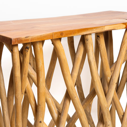 The Sherwood Console Table is a breathtaking fusion of modern minimalism and raw nature. Featuring a base crafted from a dense thicket of natural branches, it creates a stunning "forest floor" aesthetic that feels both light and substantial. Topped with a sleek, polished timber surface, this table serves as a functional work of art, perfect for entryways, hallways, or as a statement piece behind a sofa.


Branch-Work Base: Meticulously arranged natural branches provide a unique, organic foundation and incredible visual texture.

Sleek Display Top: A smooth, rectangular surface that provides the perfect stage for lamps, books, or curated decor.

Artisan Statement: Hand-assembled to ensure balance and durability while maintaining the wild character of the wood.

Light &amp; Airy: The open-structure base allows light to pass through, making it ideal for maintaining a sense of space in narrow hallways
