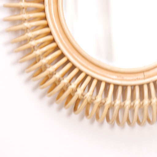 Transform your living space into a sanctuary of style with the Luaz Cane Mirror. Embodying the "Urban Oak" philosophy where rustic materials meet refined design, this handcrafted mirror is far more than just a reflective surface—it is a piece of functional wall art.
Featuring a rhythmic, sunburst-inspired frame meticulously shaped into intricate, looped construction, it anchors your wall with warmth and a sense of timeless Mediterranean sophistication. In a world of mass-produced plastic decor, the Luaz stands out with its genuine natural materials, blending the airy feel of coastal design with bohemian warmth to gracefully elevate your interior.
Why You'll Love It


Artisan Cane Craftsmanship: Detailed with a gorgeous, looped sunburst frame hand-shaped from high-quality natural cane, bringing an immediate handcrafted soul and rich organic texture to your walls.

Perfect Decorative Scale: Measuring 60 cm in diameter, this mirror is perfectly sized for versatile placement—acting as an entry standout, a boutique bedroom vanity accent, or a key piece in a curated gallery wall.

Enhances Light &amp; Space: The superior reflective glass paired with the "visual lightness" of the airy cane frame helps maximize natural light, instantly making smaller hallways, cozy nooks, or bedrooms feel more open.

One-of-a-Kind Charm: Because our artisans prioritize structural honesty and authentic materials, the natural finish highlights the unique honey-toned character of the cane, ensuring every single mirror is a completely unique original.

Product Specifications



Attribute
Details




Type
Wall-Mounted Decorative Mirror


Material
100% Authentic Natural Cane &amp; Premium Glass


Style
Bohemian / Coastal / Scandinavian / Modern Farmhouse


Finish
Hand-Shaped Natural Honey-Toned Finish


Overall Dimensions
60 cm Diameter


Frame Thickness
2 cm


Usage
Ideal for Entryways, Bedrooms, and Living Spaces


