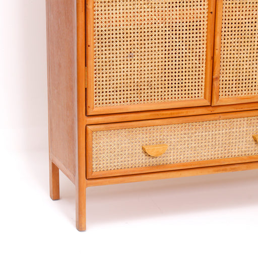 Elevate your storage capability with the breathtaking Novara Cabinet. Embodying the core Urban Oak design ethos—where rugged natural elements seamlessly fuse with sleek, contemporary urban engineering—this handcrafted double-door armoire is a masterclass in organic modernism.
By balancing a warm, hand-polished timber body with the delicate, breathable weave of genuine natural rattan, it anchors any living space with warmth and curated designer luxury. In a furniture market saturated with lightweight flat-pack particle board and synthetic veneer laminates, the Novara stands tall as a sturdy, reliable legacy piece built for the modern curator.
Why You'll Love It


Breathable Natural Rattan Webbing: Designed with premium, hand-woven natural rattan cane panels across both main doors and the lower storage drawer front. This breathable, organic material provides proper internal ventilation while adding a soft, bohemian texture and visual lightness.

Soft-Edged Retro Architecture: Showcases elegant, rounded pill-shaped framing along its upper corners. This Mid-Century Modern architectural silhouette softens the straight lines of modern interiors, making it an immediate focal point.

Integrated Drawer &amp; Cabinet Storage: Equipped with two full-length wardrobe doors fitted with custom semi-circle wood pull handles, paired with a wide lower accent drawer. It provides the ultimate combination of hidden shelving organization and quick-access utility storage.

Authentic Solid Wood Craftsmanship: Meticulously handcrafted from premium sustainable solid timber. True to a philosophy of structural honesty, this heavy-duty wardrobe features exceptional durability, pristine joinery, and a weighted, wobble-free base.

Product Specifications



Attribute
Details




Material
100% Genuine Sustainable Solid Timber &amp; Authentic Rattan Webbing


Style
Mid-Century Modern / Organic Boho / Minimalist Luxury


Hardware
Custom Integrated Semi-Circle Wooden Pull Handles


Configuration
2 Main Cabinet Doors (with Internal Shelving) &amp; 1 Large Bottom Accent Drawer


Overall Dimensions
170 cm (Height) × 100 cm (Length/Width) × 40 cm (Depth)


Usage
Ideal for Bedroom Wardrobes, Linen Organization, Living Room Sideboards, or Executive Office Storage


